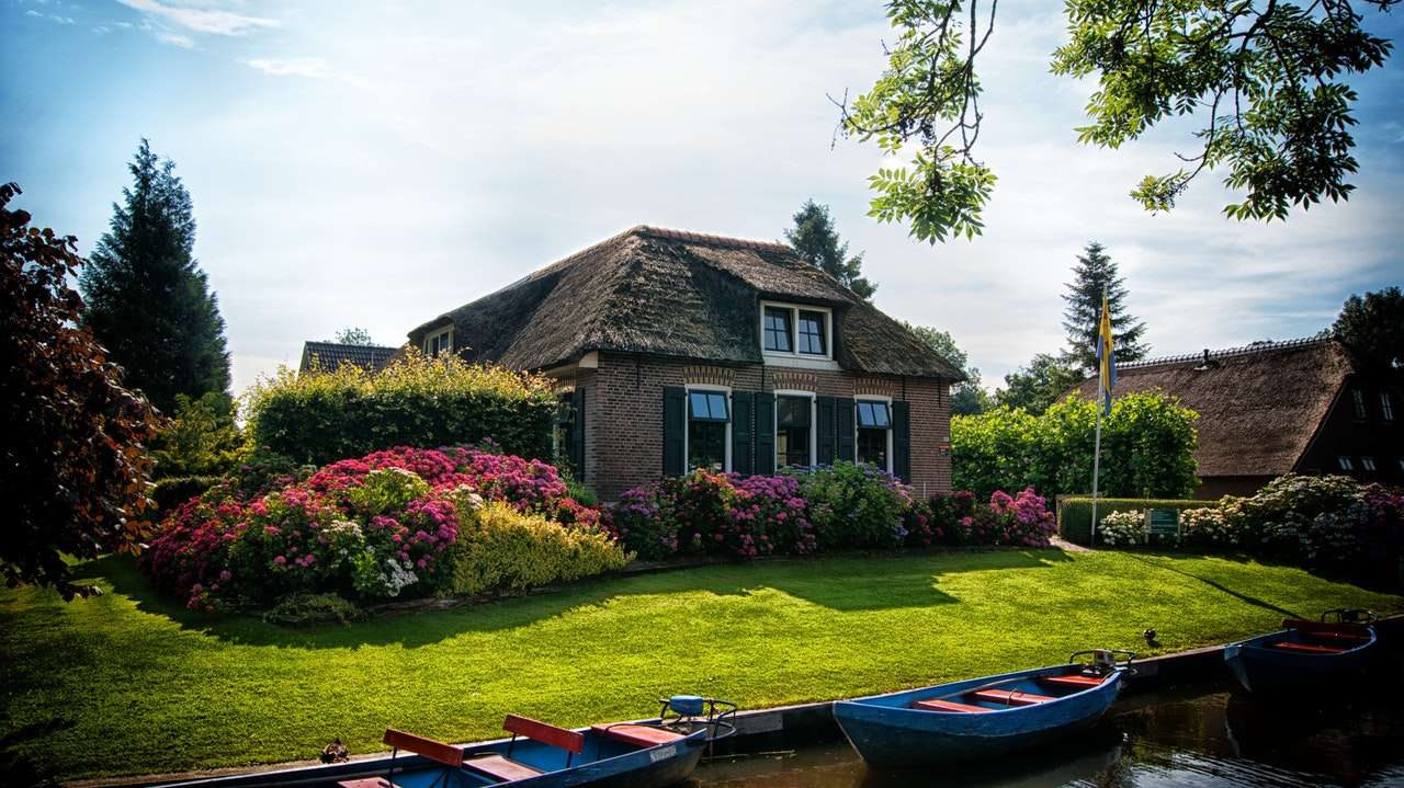 A holiday cottage near river with boats